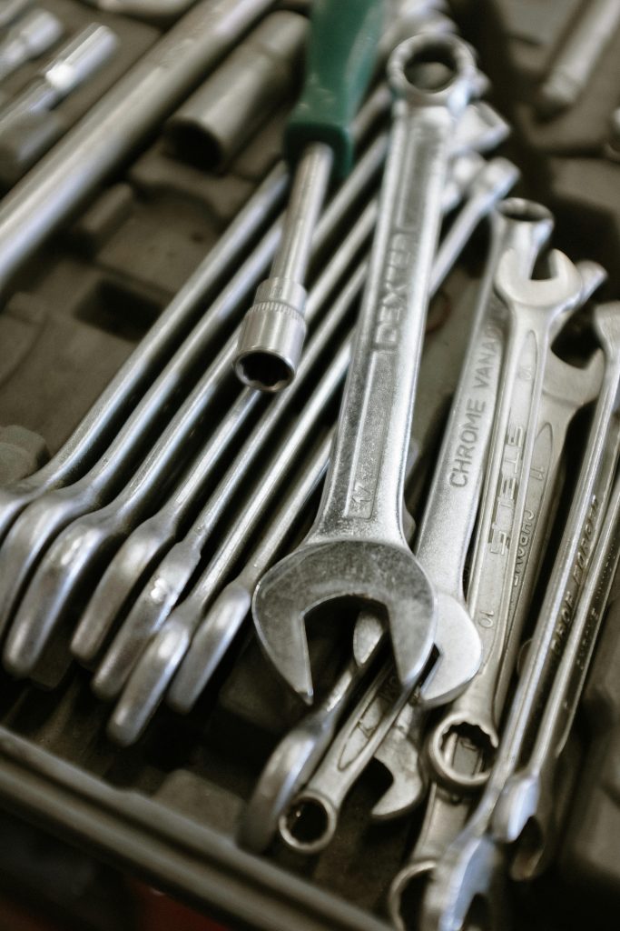 Spanners and tools in a metal toolbox