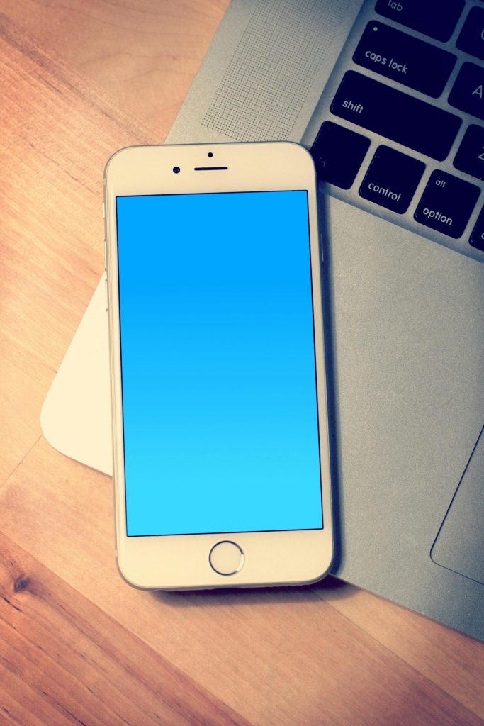 Smartphone resting on a laptop keyboard